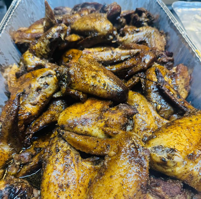 Smoked chicken wings in a foil pan at Shiloh’s Lounge