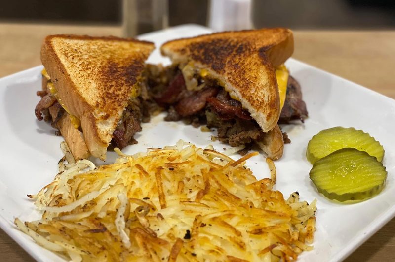 Breakfast sandwich with hash browns and pickles at Shiloh’s Lounge
