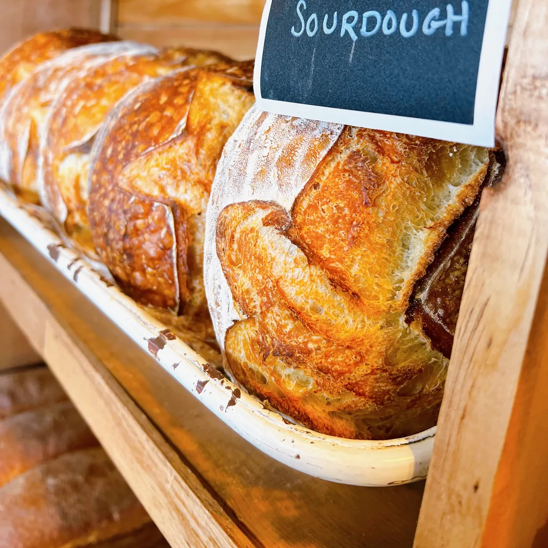 Sourdough boules on the bread shelf at Niko’s Bakery & Cafe