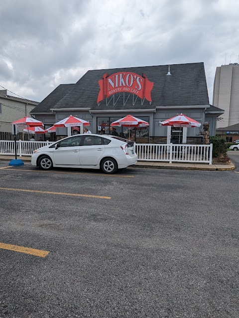 Niko’s Bakery & Cafe storefront with red-and-white patio umbrellas